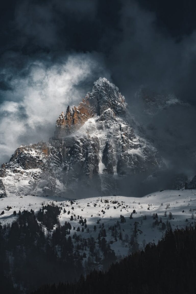 Jagged Mountain Towering above Snow Field